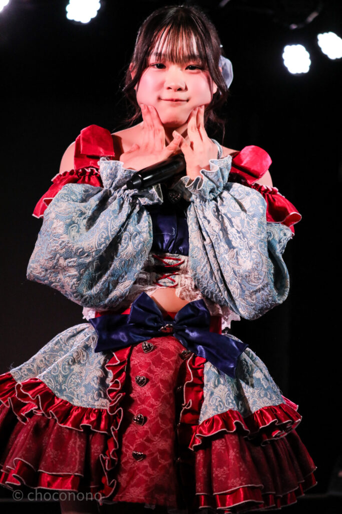 embellir(あんべりー)の恋羽あゆう(こはねあゆう)ちゃんをライブ中に撮影した写真。 こちらを真っ直ぐ見つめながらほっぺをむにむにしている。
2025年12月21日 中野坂上S.U.B Tokyo IDOL ADVENTUREにて撮影。